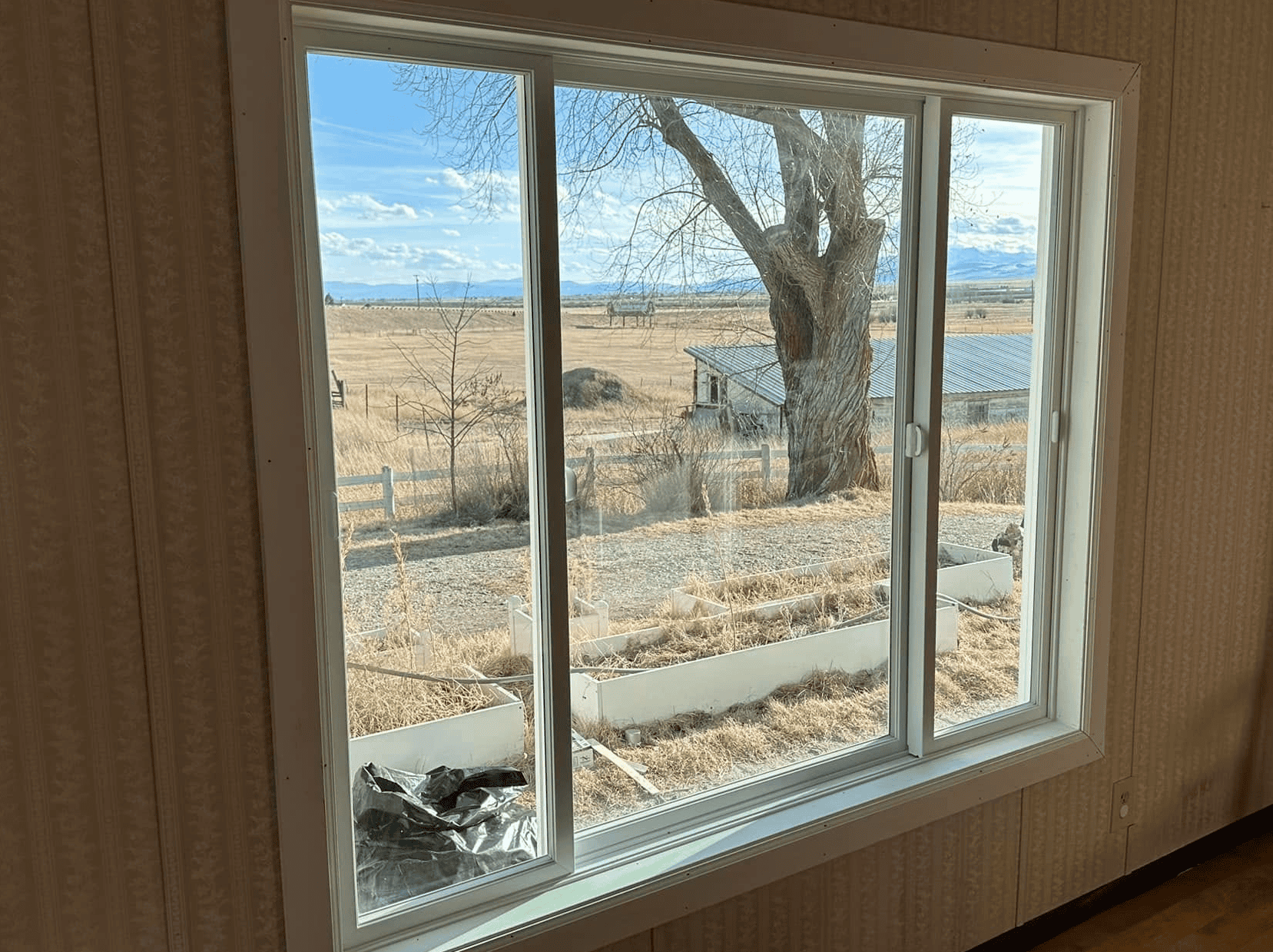 Window installation with a scenic rural landscape view.