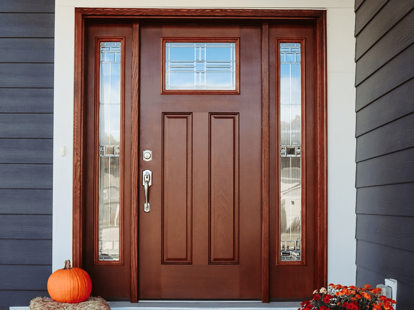 Front door with sidelights and decorative glass panels.